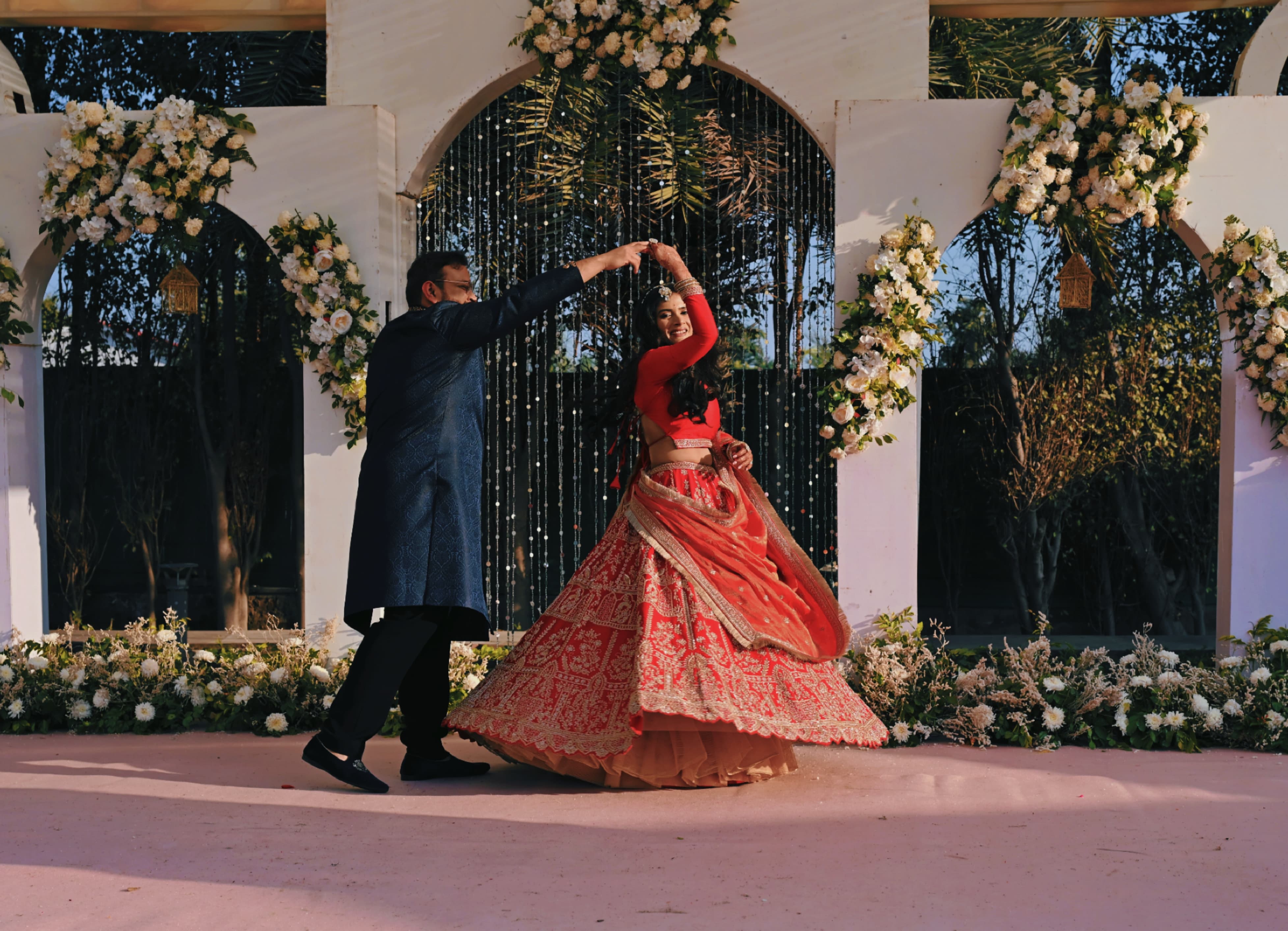 Kashish twirling in her red lehenga at the sangeet
