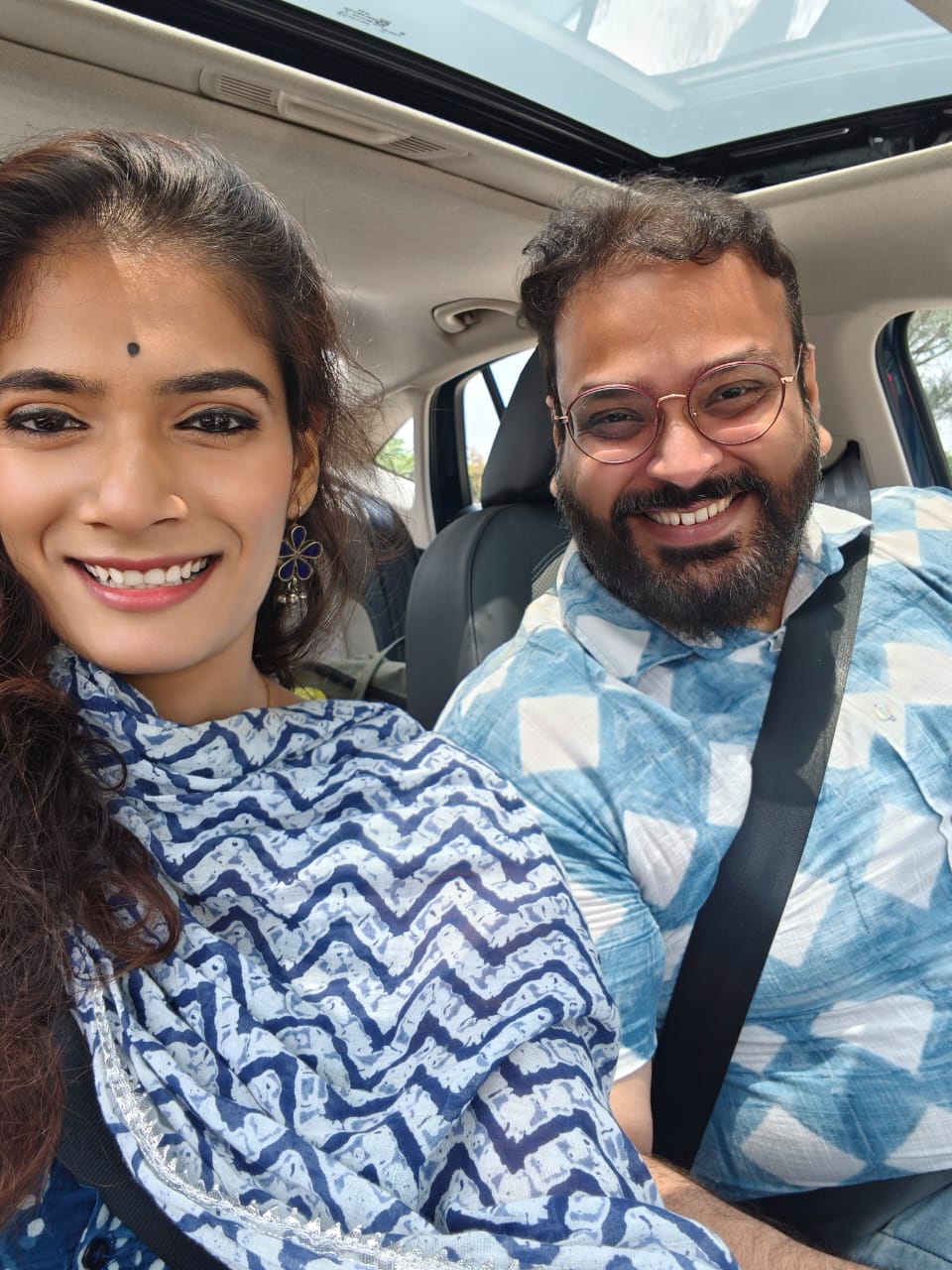 Rahul and Kashish smiling together in the car